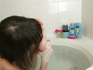 Junges Mädchen leckt ihre füsse im Badezimmer